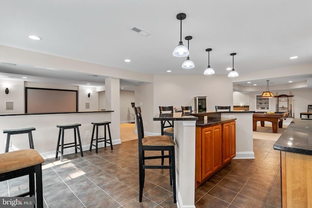 6000 Clairemont Dr, Owings, MD 20736 - kitchen featuring a kitchen bar, recessed lighting, dark tile patterned flooring, billiards, and brown cabinets