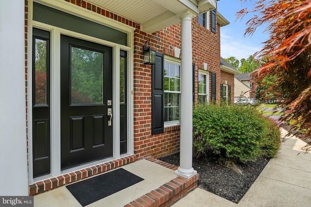 6000 Clairemont Dr, Owings, MD 20736 - doorway to property with brick siding and covered porch