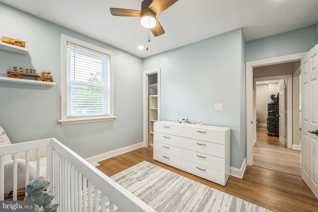 330 Date St, Warminster, PA 18974 - bedroom featuring wood finished floors, a nursery area, baseboards, and a ceiling fan