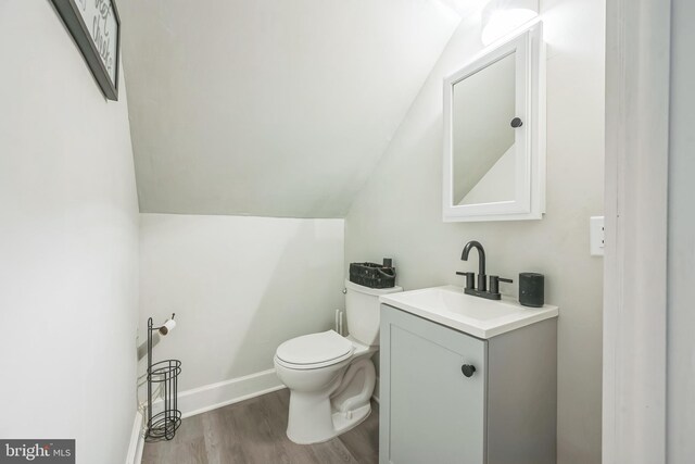 330 Date St, Warminster, PA 18974 - half bathroom with vanity, vaulted ceiling, wood finished floors, toilet, and baseboards