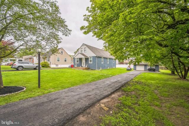 330 Date St, Warminster, PA 18974 - bungalow-style house with a front yard, an outdoor structure, and a garage