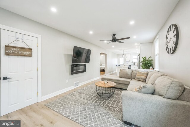 330 Date St, Warminster, PA 18974 - living area with arched walkways, wood finished floors, a ceiling fan, recessed lighting, and baseboards