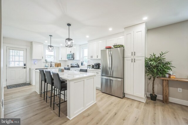 330 Date St, Warminster, PA 18974 - kitchen featuring appliances with stainless steel finishes, white cabinetry, a center island, light wood-style flooring, and recessed lighting