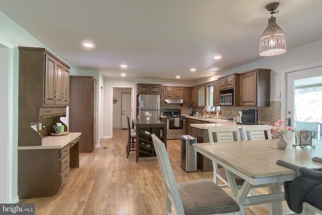 46 Gelsinger Rd, Reading, PA 19608 - kitchen with stainless steel appliances, tasteful backsplash, under cabinet range hood, light countertops, and pendant lighting
