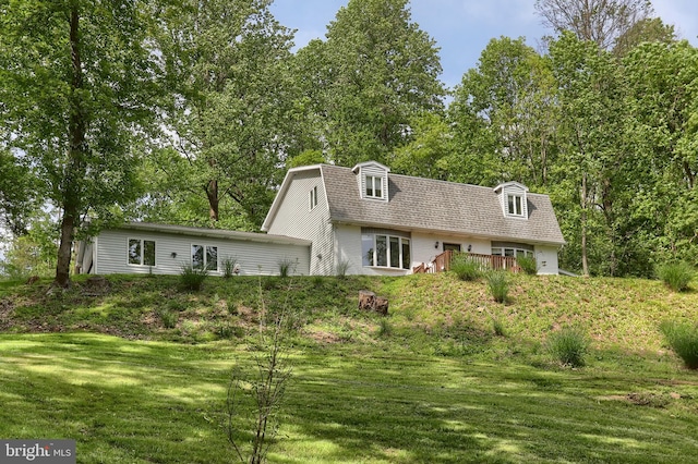 46 Gelsinger Rd, Reading, PA 19608 - view of front facade featuring a front yard, a gambrel roof, roof with shingles, and view of wooded area