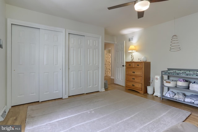 46 Gelsinger Rd, Reading, PA 19608 - bedroom featuring two closets, wood finished floors, and a ceiling fan