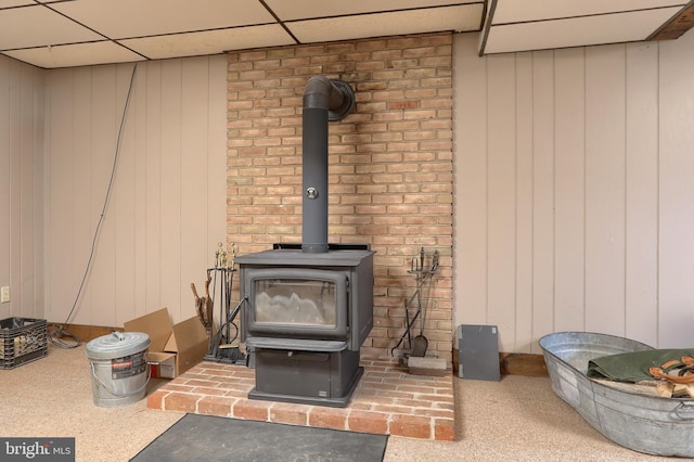 46 Gelsinger Rd, Reading, PA 19608 - detailed view of a wood stove, a paneled ceiling, and wood walls