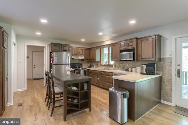 46 Gelsinger Rd, Reading, PA 19608 - kitchen featuring appliances with stainless steel finishes, under cabinet range hood, light wood-style floors, open shelves, and recessed lighting