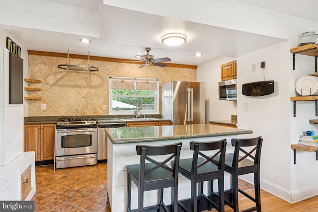 5721 Greenspring Ave, Baltimore, MD 21209 - kitchen with stainless steel appliances, open shelves, backsplash, a kitchen breakfast bar, and a ceiling fan