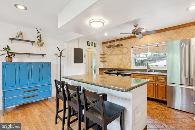 5721 Greenspring Ave, Baltimore, MD 21209 - kitchen with appliances with stainless steel finishes, a sink, open shelves, a kitchen bar, and recessed lighting
