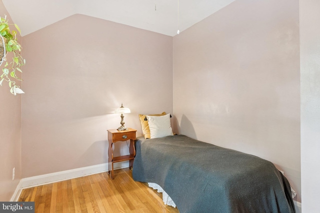 5721 Greenspring Ave, Baltimore, MD 21209 - bedroom with light wood-style flooring, lofted ceiling, and baseboards