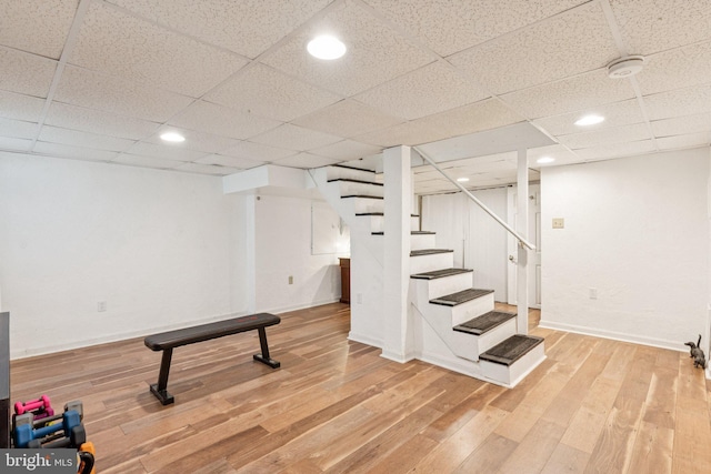 5721 Greenspring Ave, Baltimore, MD 21209 - finished below grade area with stairs, wood finished floors, baseboards, a paneled ceiling, and recessed lighting