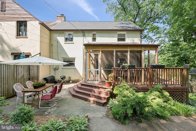 5721 Greenspring Ave, Baltimore, MD 21209 - rear view of property with a sunroom, stucco siding, a patio, and a chimney