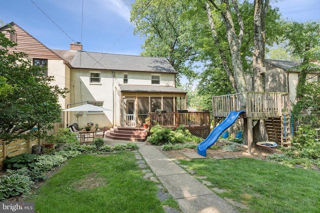 5721 Greenspring Ave, Baltimore, MD 21209 - back of house with a sunroom, a playground, a chimney, stucco siding, and a shingled roof
