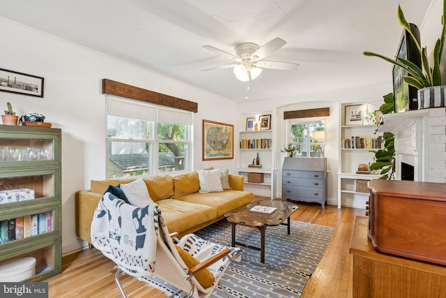 5721 Greenspring Ave, Baltimore, MD 21209 - living room with ceiling fan, light wood-style floors, a fireplace, and built in shelves