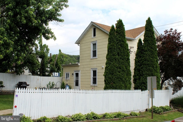 301 E 3rd St, Avondale, PA 19311 - view of front facade featuring a fenced front yard and roof with shingles