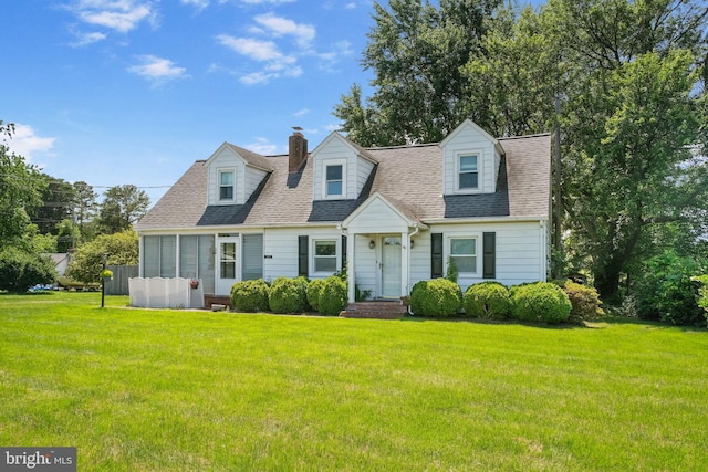 301 Hamilton Blvd, Warsaw, VA 22572 - cape cod house featuring a front lawn, a shingled roof, and a chimney