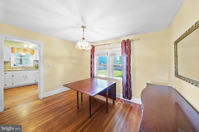 301 Hamilton Blvd, Warsaw, VA 22572 - dining space with baseboards, healthy amount of natural light, light wood-type flooring, and a chandelier