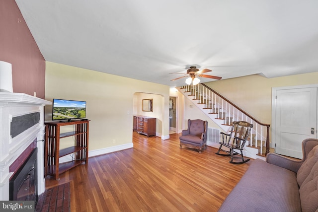 301 Hamilton Blvd, Warsaw, VA 22572 - living area featuring a fireplace, stairway, wood finished floors, ceiling fan, and baseboards