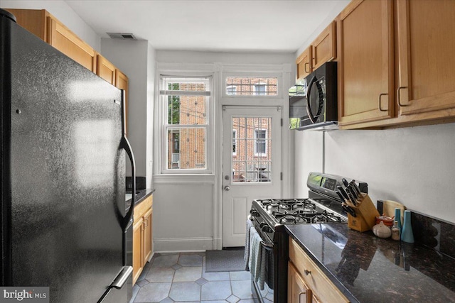 233 Rhode Island Ave NW, Washington, DC 20001 - kitchen featuring black appliances, light tile patterned floors, and dark stone counters