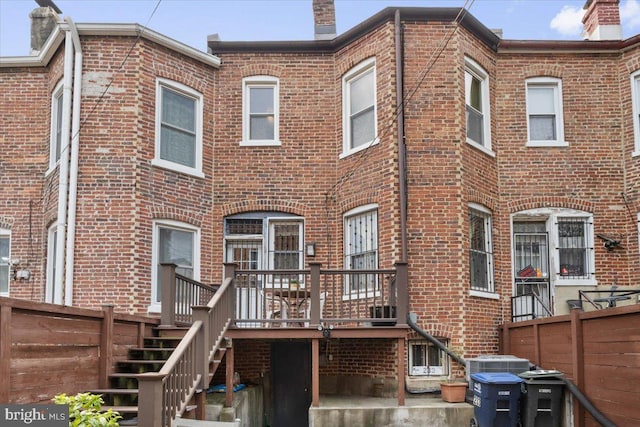 233 Rhode Island Ave NW, Washington, DC 20001 - back of property with brick siding, stairs, a wooden deck, and a chimney