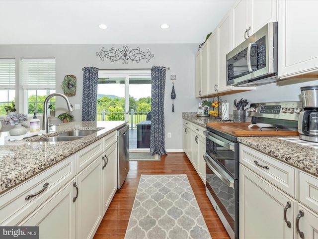1419 Ramblewood Dr, Emmitsburg, MD 21727 - kitchen with stainless steel appliances, a sink, dark wood finished floors, white cabinets, and recessed lighting