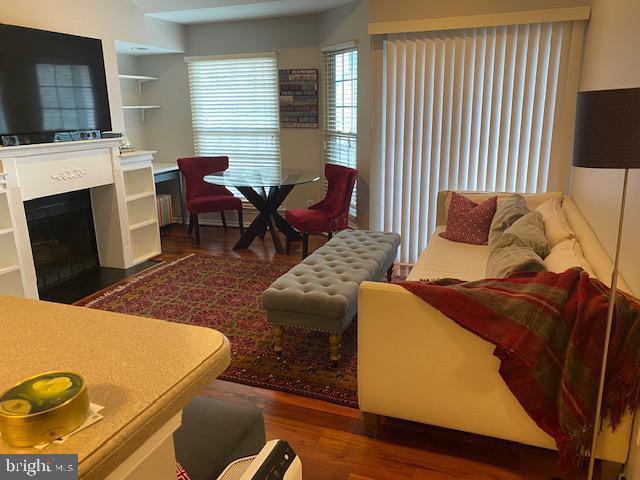 3916 Penderview Dr Unit 435, Fairfax, VA 22033 - living area featuring wood finished floors and a fireplace with flush hearth