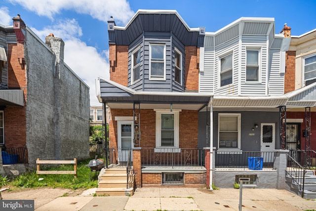 2729 W Seltzer St, Philadelphia, PA 19132 - view of property featuring a porch and brick siding