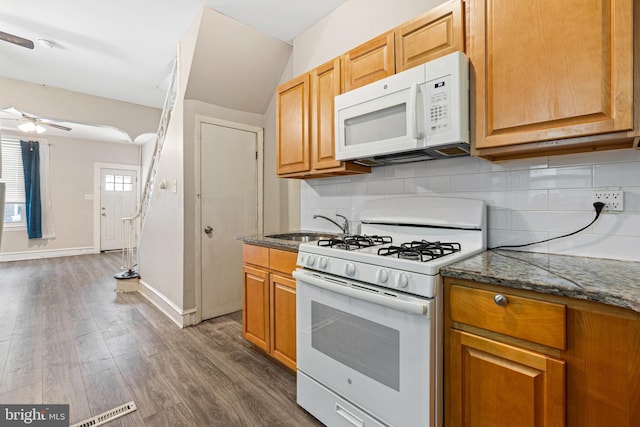 2729 W Seltzer St, Philadelphia, PA 19132 - kitchen with white appliances, a ceiling fan, backsplash, dark wood-type flooring, and a sink