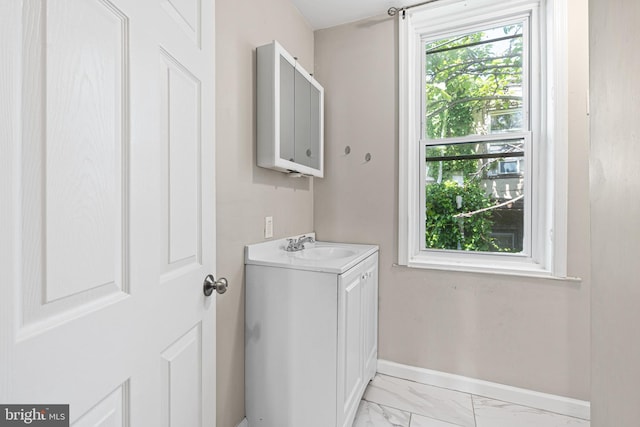 2729 W Seltzer St, Philadelphia, PA 19132 - bathroom featuring vanity, marble look tiles, and baseboards
