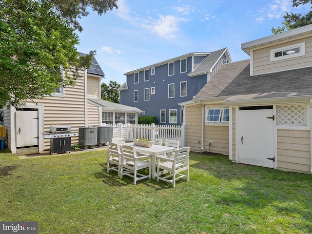 16 Delaware Ave, Rehoboth Beach, DE 19971 - view of yard featuring central AC, a sunroom, and outdoor dining area