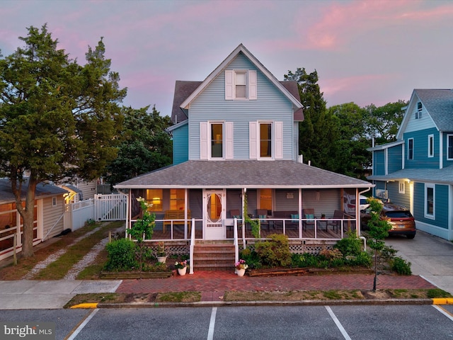 16 Delaware Ave, Rehoboth Beach, DE 19971 - farmhouse inspired home featuring covered porch, uncovered parking, a gate, and a shingled roof