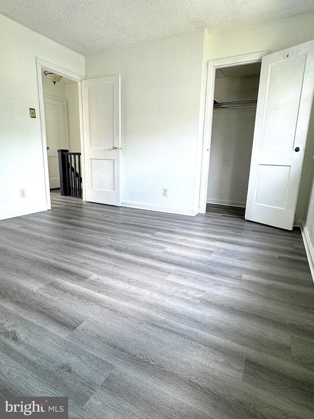 4137 Passmore St, Philadelphia, PA 19135 - unfurnished bedroom with wood finished floors, a closet, and a textured ceiling