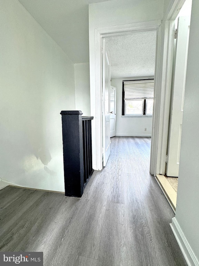 4137 Passmore St, Philadelphia, PA 19135 - hall with wood finished floors, baseboards, and a textured ceiling
