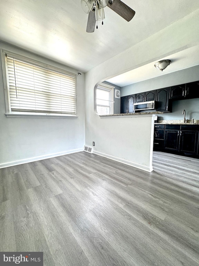4137 Passmore St, Philadelphia, PA 19135 - unfurnished living room featuring wood finished floors, ceiling fan, a sink, and baseboards