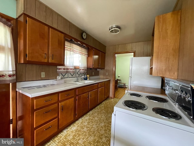210 Potomac St, Cumberland, MD 21502 - kitchen with white appliances, light floors, a sink, light countertops, and brown cabinets