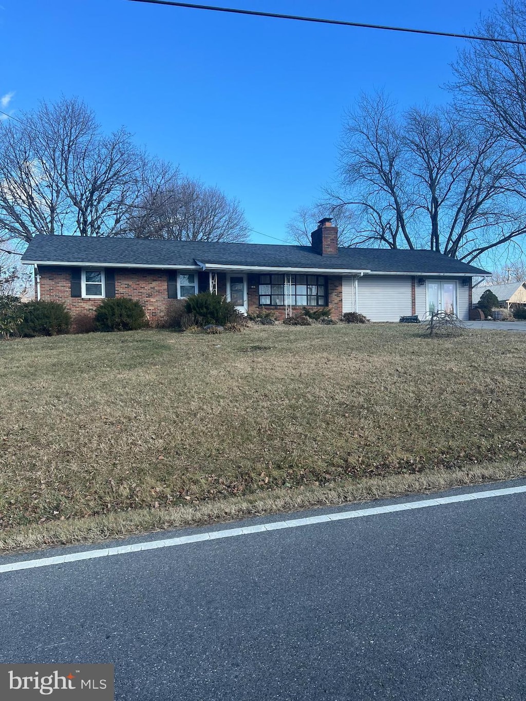 4533 Araby Church Rd, Frederick, MD 21704 - ranch-style house featuring a chimney, brick siding, a front yard, and a garage