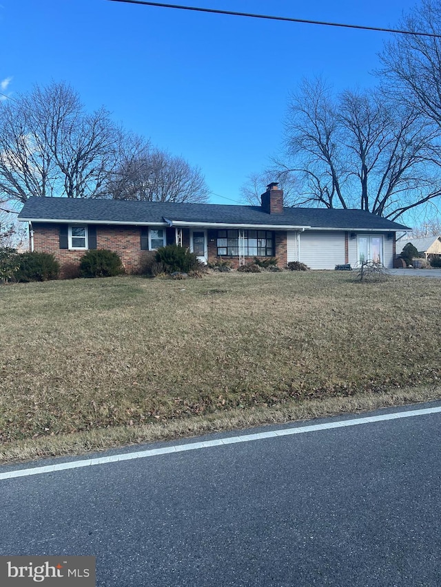 4533 Araby Church Rd, Frederick, MD 21704 - ranch-style house featuring a chimney, brick siding, a front yard, and a garage