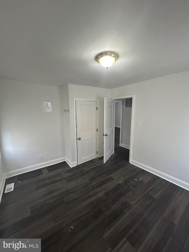 5258 Saint Charles Ave, Baltimore, MD 21215 - unfurnished room featuring baseboards and dark wood-type flooring