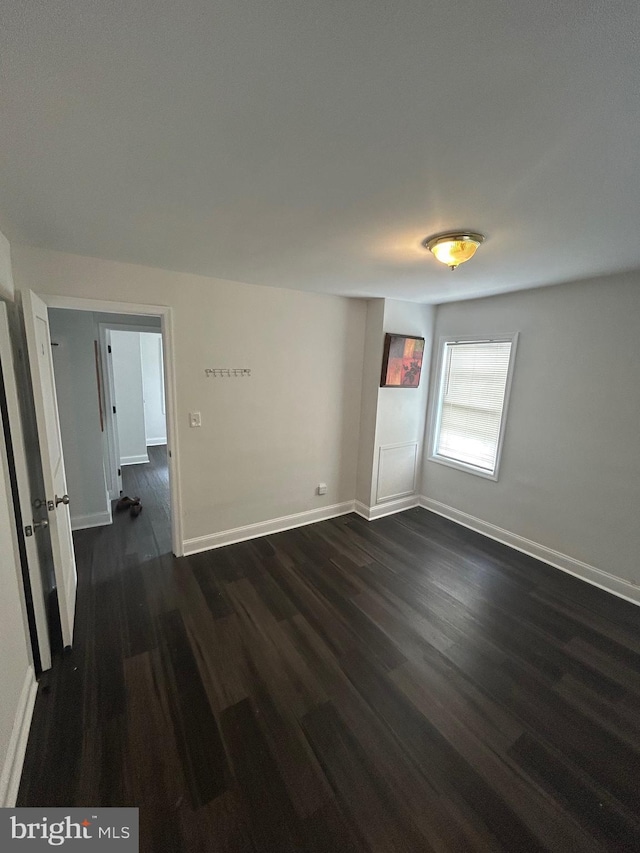5258 Saint Charles Ave, Baltimore, MD 21215 - unfurnished room featuring dark wood-style flooring and baseboards