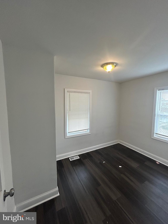 5258 Saint Charles Ave, Baltimore, MD 21215 - spare room with dark wood-type flooring and baseboards