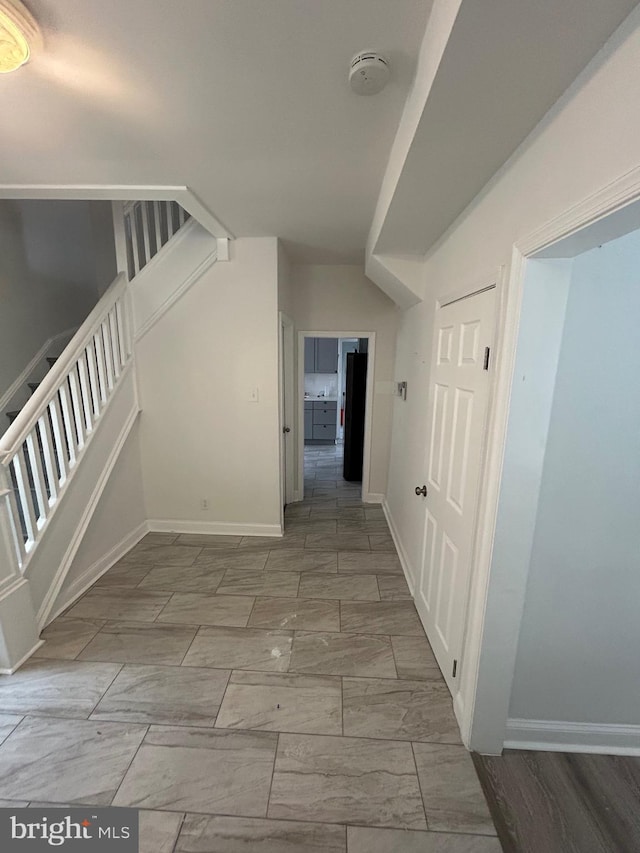 5258 Saint Charles Ave, Baltimore, MD 21215 - corridor with stairway, marble finish floors, and baseboards