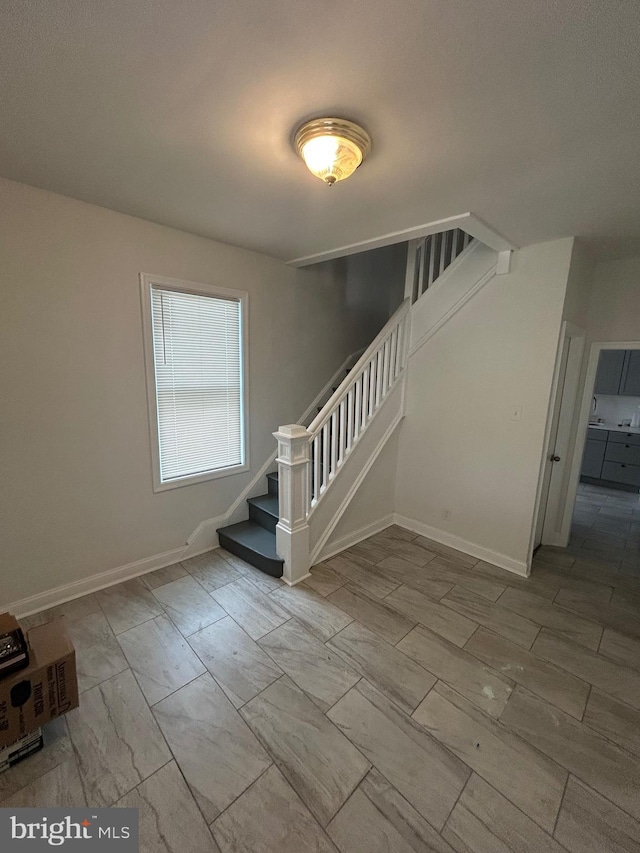 5258 Saint Charles Ave, Baltimore, MD 21215 - staircase featuring baseboards