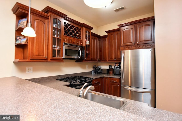 605 N Atlantic Ave Unit 204, Collingswood, NJ 08108 - kitchen with appliances with stainless steel finishes, a sink, glass insert cabinets, and hanging light fixtures