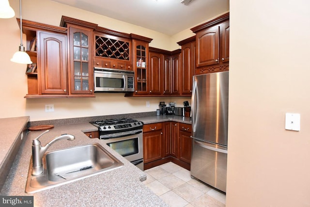 605 N Atlantic Ave Unit 204, Collingswood, NJ 08108 - kitchen featuring appliances with stainless steel finishes, a sink, glass insert cabinets, light tile patterned flooring, and decorative light fixtures