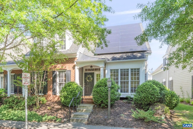 5625 Upland Dr, Crozet, VA 22932 - new england style home with brick siding, solar panels, and roof with shingles
