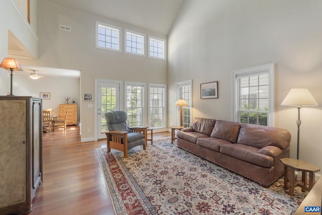 5625 Upland Dr, Crozet, VA 22932 - living room with healthy amount of natural light, a towering ceiling, wood finished floors, and ceiling fan
