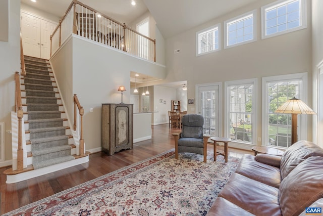 5625 Upland Dr, Crozet, VA 22932 - living area featuring wood finished floors, plenty of natural light, baseboards, a towering ceiling, and stairs
