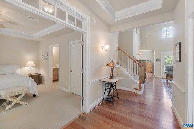 5625 Upland Dr, Crozet, VA 22932 - bedroom featuring a raised ceiling, ornamental molding, wood finished floors, and baseboards