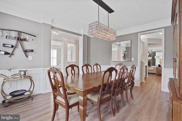 42863 Glyndebourne Ct, Broadlands, VA 20148 - dining room featuring a decorative wall, light wood-type flooring, a wainscoted wall, and crown molding